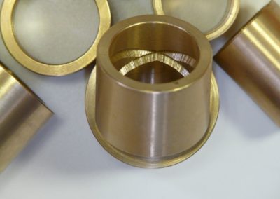 A close up of some brass cups on top of a table